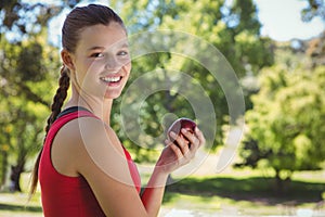 Fit woman holding bag of healthy groceries