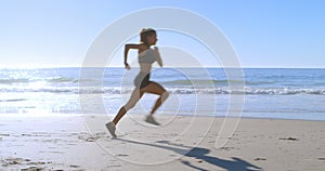 Fit woman jogging in the beach 4k