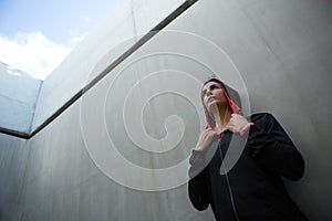 Fit woman leaning on wall