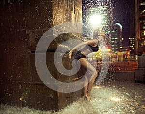 Fit woman making a figure in a fountain