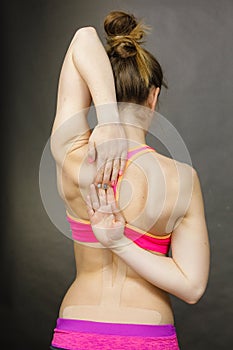 Fit woman with medical kinesio taping on back