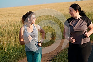 Fit woman motivate her friend at outdoor jogging