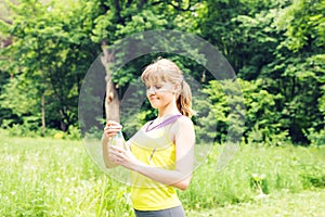 Fit woman outdoors holding a bottle of water