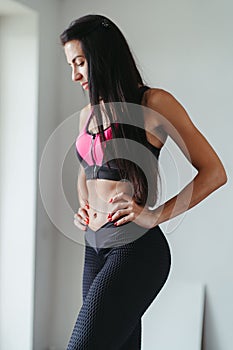 Fit woman with perfect muscular body in activewear