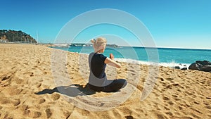 Fit woman practicing yoga outdoors at sunny day. Young woman meditating