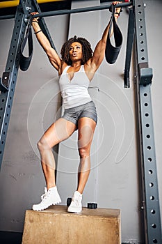 Fit woman preparing for the pull-ups on the horizontal bar