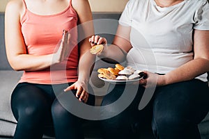 Fit woman refusing junk snacks and sweets