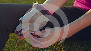 Fit woman removing glove from hand. Close up of woman hands remove sport gloves