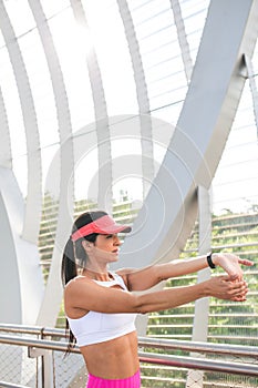 Fit woman runner stretching outdoors
