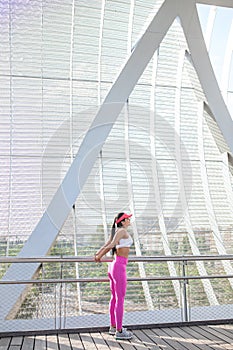 Fit woman runner stretching outdoors