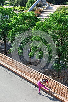 Fit woman runner stretching outdoors