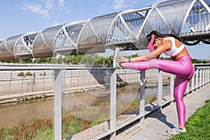 Fit woman runner stretching outdoors