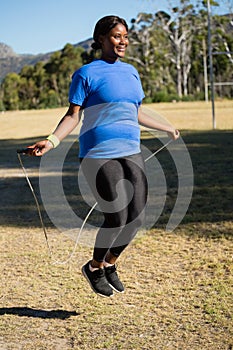 Fit woman skipping rope in the park