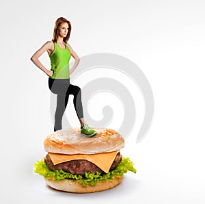 Fit woman standing on a cheeseburger