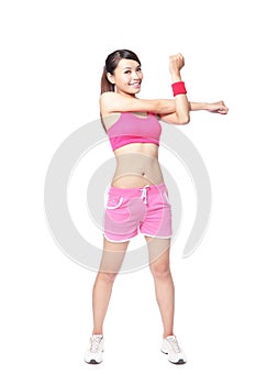 Fit woman stretching her arm to warm up