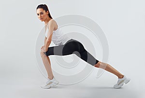 Fit woman stretching her leg to warm up.