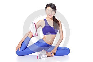 Fit woman stretching her leg to warm up