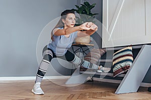 Fit woman stretching legs Lateral Lunge exercise.