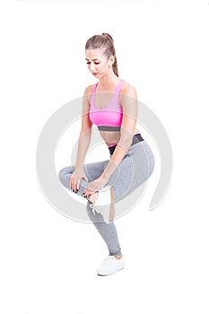 Fit woman stretching one leg before training