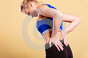 Fit woman suffering from back pain