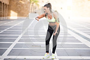 Fit woman timing her heart rate with watch