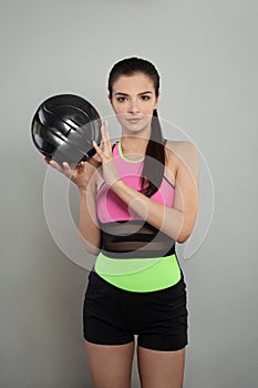 Fit woman wearing sportswear with ball portrait