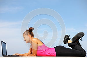 Fit woman working on computer