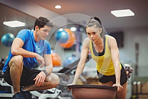 Fit woman working out with trainer