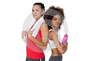 Fit women standing with waterbottle and towel