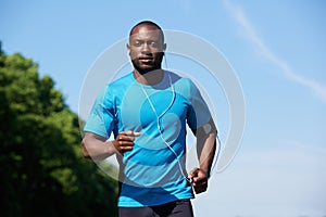 Fit young african american man running outdoors