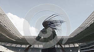 Fit young african american woman with dreadlocks doing work out outdoors at the stadium in slow-motion