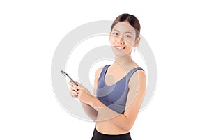 A fit young asian woman in sportswear using a smart phone, possibly managing her fitness.