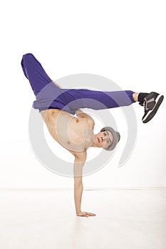 Fit young dancer in breakdance position