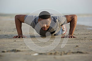 Fit young man doing push ups outdoors