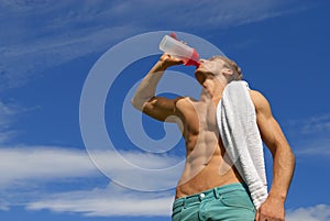 Fit young man drinking water