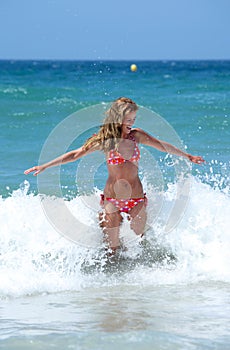 fit young woman being splashed by a wave