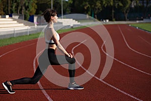 Fit young woman doing lunges