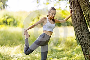 Fit young woman exercising in nature photo