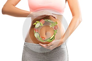 Fit, young woman holding a circle made out of vegetables