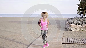 Fit young woman jogging on a beach