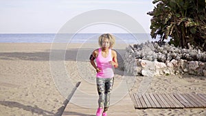 Fit young woman jogging on a beach