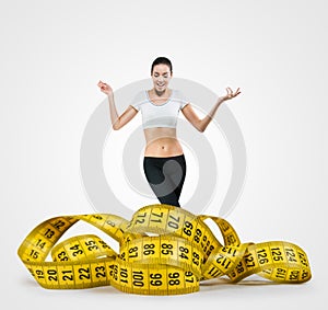 Fit young woman with a large measuring tape