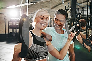 Fit young woman lifting weights during a gym class