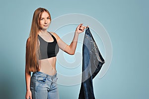 Fit young woman in loose jeans