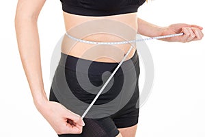 Fit young woman measures waist circumference belly after sport diet photo