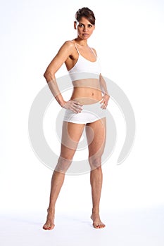 Fit young woman standing in white sports underwear