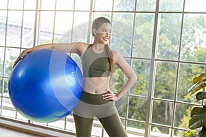 Fit young women exercising with fitness ball at home, sport and healthy lifestyle concept