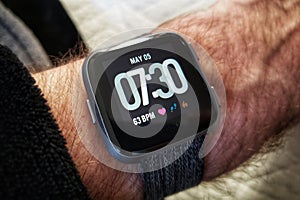 Fitbit Versa smartwatch on a man`s arm photo