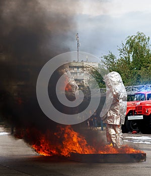 Fiteman in a fire proximity suit puts on fire.Fireman in a fire proximity suit which made to protect him from hazardous materials