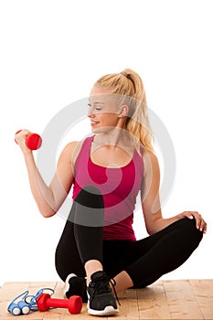 Fitnes - Blonde young woman working out with dumbbells isolated